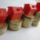 Monopoly hotel atop of a pile of coins symbolizing inheritance tax